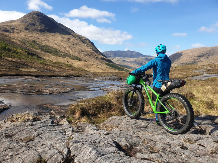 Bikepacking mountain views waterproof jacket and top tube bag