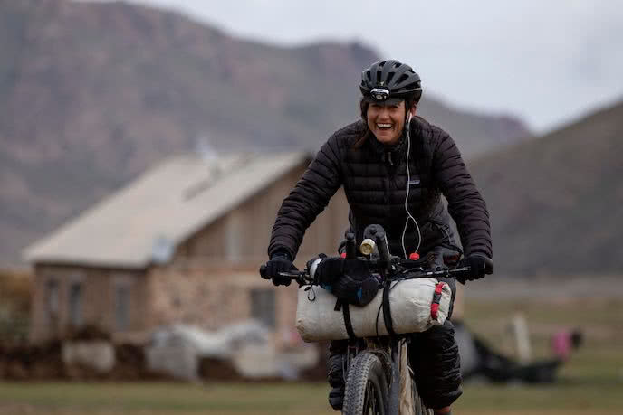Lael wilcox riding her bike with bikepacking bags